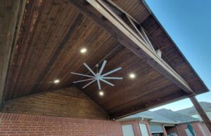 Large commercial fan installed for covered patio construction